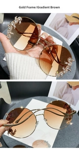 Macro detail of gold rimless sunglasses with leopard rhinestone accents and brown lenses
