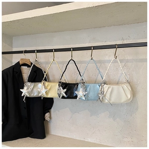 Detailed display of ruched cloud bags in five colors with woven straps and star charms