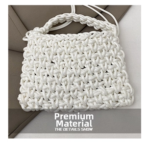 Detail shot of white chunky woven handbag showing intricate 3D mesh texture and soft material