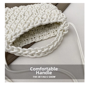 Detailed close-up of white woven handbag handle with textured rope craftsmanship