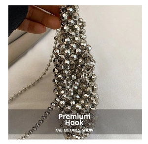 Detail view of the silver beaded handbag showing the high-quality metal chain hook