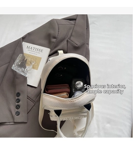 Interior view of off-white mini backpack showing space for phone, wallet and water bottle