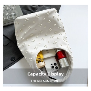 Interior view showing the large capacity of the white beaded tote bag with daily items