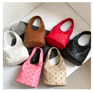 Flat lay of hobo handbags in six colors with 3D floral rivet studs and stylish handle