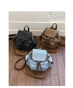 Three durable denim backpacks in grey, brown, and blue with adjustable leather straps