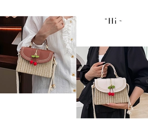 Detailed view of woven straw handbags featuring leather flaps and cherry pendant accents