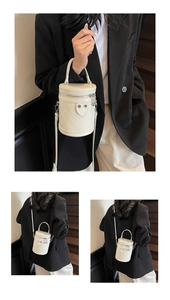 Detailansicht der gesteppten weißen Zylindertasche mit Kettenriemen und Metallreißverschluss