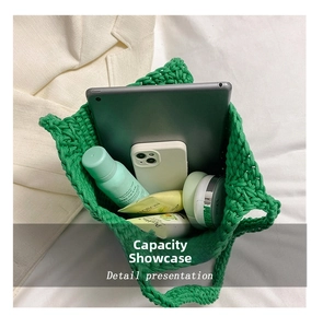 Spacious interior of a green hand-woven tote bag filled with everyday essential items