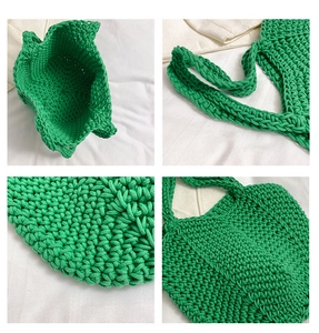 Detail view of green handmade straw tote bag showing thick woven texture and strap design