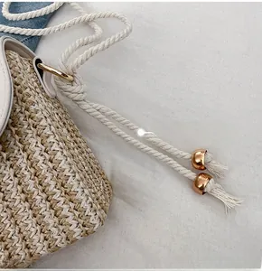Close-up of straw woven texture with rope strap and golden mirror bead detail