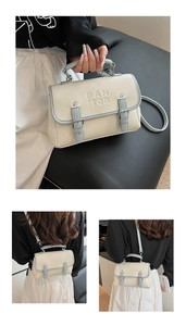 Detail of retro beige and blue crossbody bag with PAN TOR logo and adjustable straps