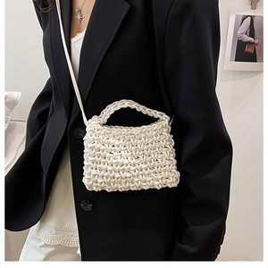 Detail of white chunky woven handbag showing intricate texture and spiral knit pattern