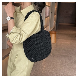 Detail of black hand-woven crochet tote bag with dense texture and minimalist retro style