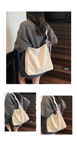 Detail of cream white tote bag with pink drawstring accents on a dark wooden staircase