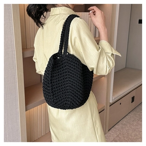 Detail of black crochet tote bag showing thick cotton rope texture and handmade weave pattern