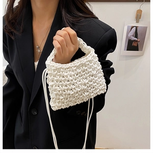 Detail of white hand-woven texture on minimalist bag with thick tubular fabric design