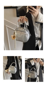 Detail of silver baseball-themed pillow bag with glove charm and baseball stitching