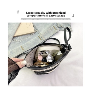 Internal view of striped crossbody bag showing large capacity for phone and makeup