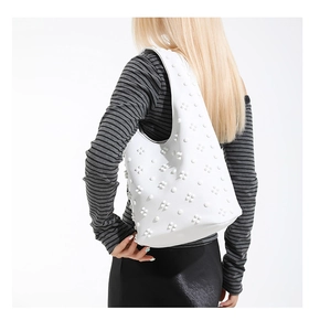 Close-up of the textured floral relief pattern on this white large capacity tote shoulder bag