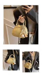 Detail of yellow pillow bag with baseball stitching, chic logo, and sport charms accessories