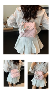 Detail of pink quilted bag with silver star charms and metallic rivet embellishments