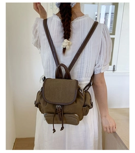 Retro canvas backpack with brown leather trim and multiple pockets for commuting