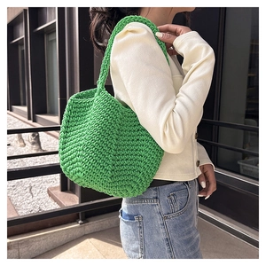 Close-up of bright green woven tote bag showing thick rope texture and handmade craft