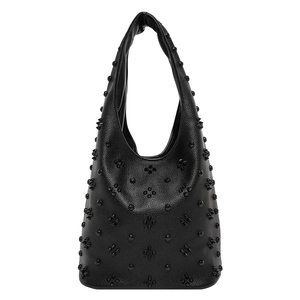 Detail of black lychee grain leather with metallic studs in a gothic cross pattern