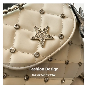 Detail of quilted leather underarm bag with star-shaped crystal buckle and chain