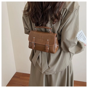 Detailed back view of a vintage brown versatile backpack on model with matte faux leather texture