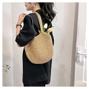 Detail of hand-woven straw tote bag with reinforced shoulder strap for summer vacation