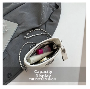 Interior capacity display of quilted white chain shoulder bag with cosmetics