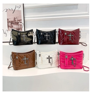 Close-up of quilted chain bucket bags in multiple colors with gothic cross charms