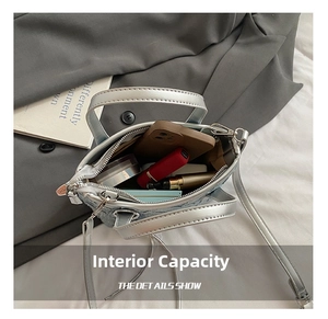 Interior view showing the capacity of a silver mini bag with a phone and lipstick