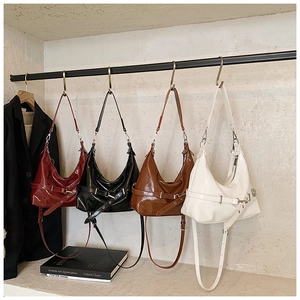 Detail showing minimalist tote bags in burgundy, black, brown, and cream faux leather