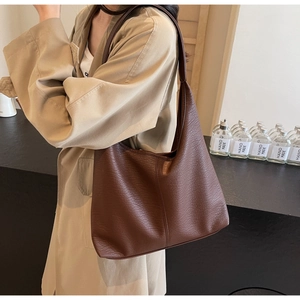 Gros plan d'un grand sac cabas marron en cuir PU souple avec texture à grain naturel