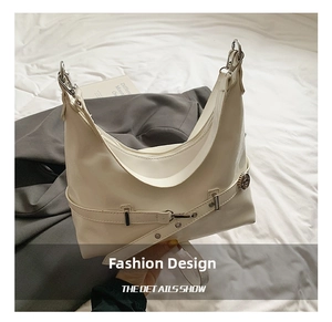 Close-up of the silver buckle and adjustable strap on a white leather hobo underarm bag