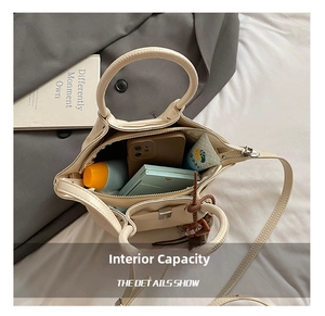 Detailed interior of a cream crossbody bag showing main compartment and side pocket for essentials