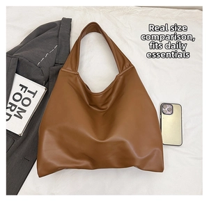 Flat lay of brown faux leather tote bag showing large capacity size comparison