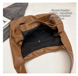 Top view of spacious interior of brown PU leather tote bag with functional zipper pocket