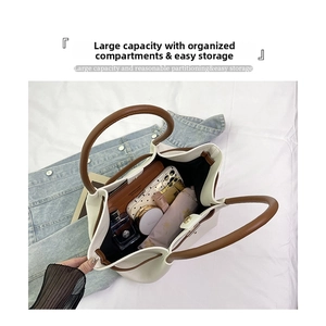 Detailed interior of a beige tote bag showing large capacity for phone and cosmetics
