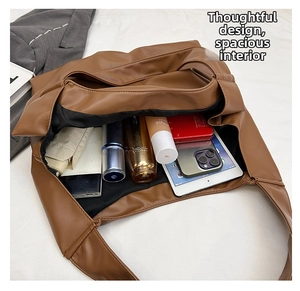 Detailed interior view of a spacious brown faux leather tote bag with daily essentials