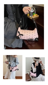 Detail of pink quilted shoulder bag with black bows and adjustable strap design