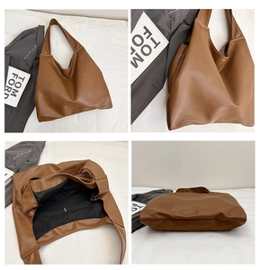 Detail view of large brown tote bag showing spacious black interior and zipper pocket