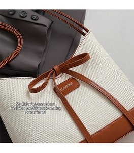 Close-up of woven bucket bag with brown leather trim and decorative bow accent