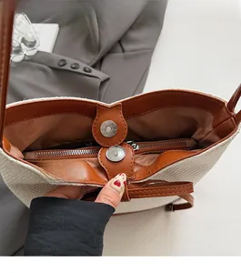 Close-up of canvas bucket bag featuring magnetic closure and internal zipper pocket detail