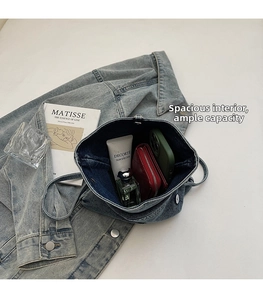 Detailed view of the large internal capacity of this vintage denim crossbody bag
