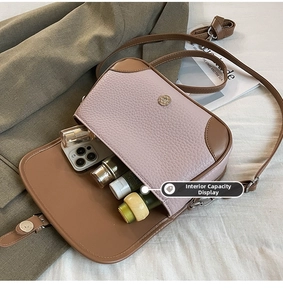 Macro shot of stylish crossbody bag interior showcasing capacity for phone and cosmetics