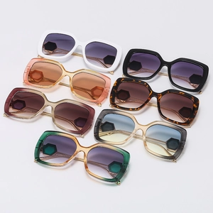 Flat lay of square sunglasses in seven colors with metal temples and hexagon accents