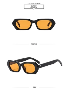 Detail view of square black frames with orange lenses and metal rivet accents